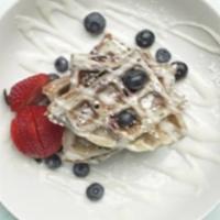 The Blueberry Belgian Waffle · Delicious blueberry waffle topped with powder sugar served and butter with maple syrup
