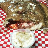 Cherry Cheesecake Calzone · Folded dough filled with cheesecake filling, graham crackers and cherry pie filling. Topped ...