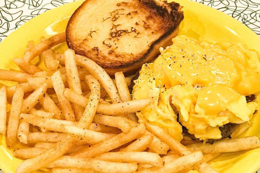 Breakfast Sandwich · Two scrambled eggs topped with American cheese on a toasted potato roll. Served with your choice of side. Add any breakfast protein for 1.00.