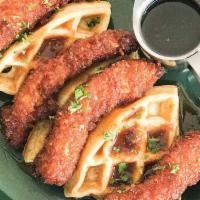 Chicken ＆ Waffles · Fried chicken tenders tossed in a sweet and spicy maple glaze served on top of a buttermilk ...