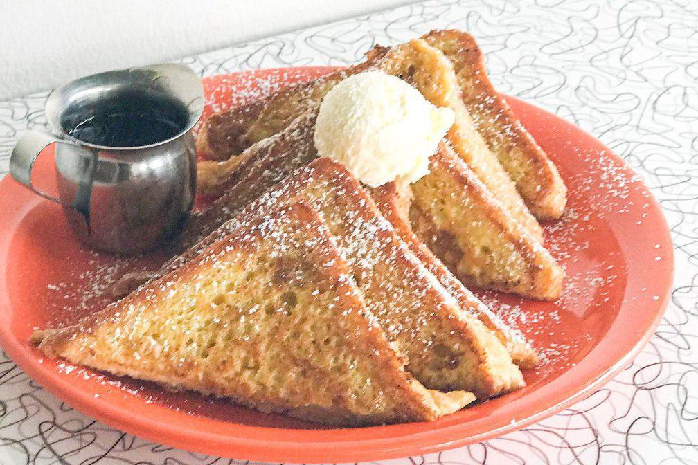 Menage A Trois Sweets · Three slices of thick cut french toast topped with powdered sugar, butter and maple syrup.