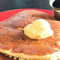 Struggling To Get Up Sweets · Two buttermilk pancakes topped with butter and served with maple syrup.