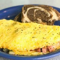 Western Omelet. · Three egg omelet filled with sauteed tomatoes, yellow onions, green peppers, ham, melted swi...