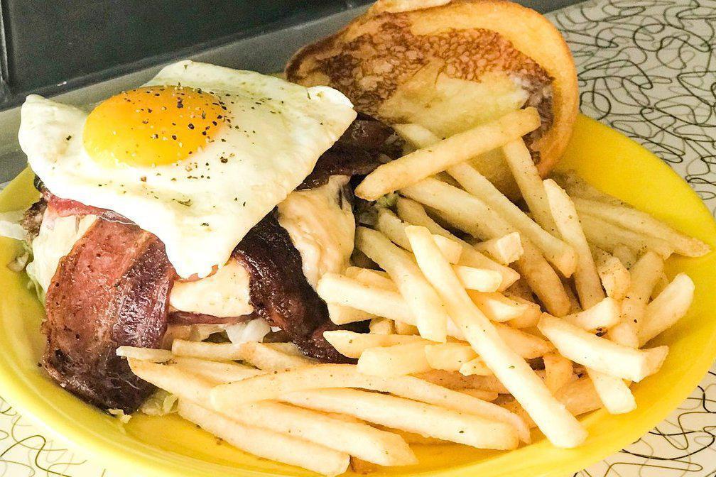 Hoe Burger Sunny Egg · Fresh ground beef grilled and topped with red onion jam, swiss cheese spread, bacon aoli and a sunny side egg. Served on a toasted potato roll with lettuce and tomato.