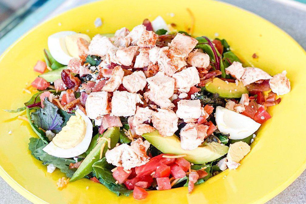 Dr Bob’s Cobb Salad · Grilled chicken, cheddar cheese, blue cheese crumbles, tomato, avocado, hard boiled egg and chopped bacon on a bed of mixed greens.