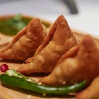 Samosa with Fried Chilies and Sauce · 3 pieces, lip-smacking savory pastry made with potato peas and grounded spices.