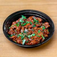 Chili Chicken · Fried chicken tossed with bell peppers & onions in chili, soy sauce & Indian spices.