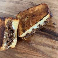 Philly cheesesteak grilled cheese · Grilled cheese with & white American cheese, steak marinated in our original sauce with onio...