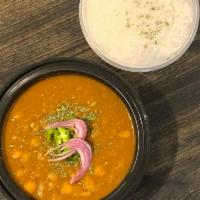 Chana Masala · Slowly cooked chickpeas with tomatoes and onions flavored with house spice served with basma...