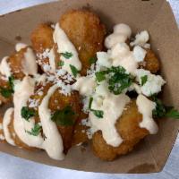 Street Corn Fritters · Fried corn fritters topped with cojita cheese & spicy mayo