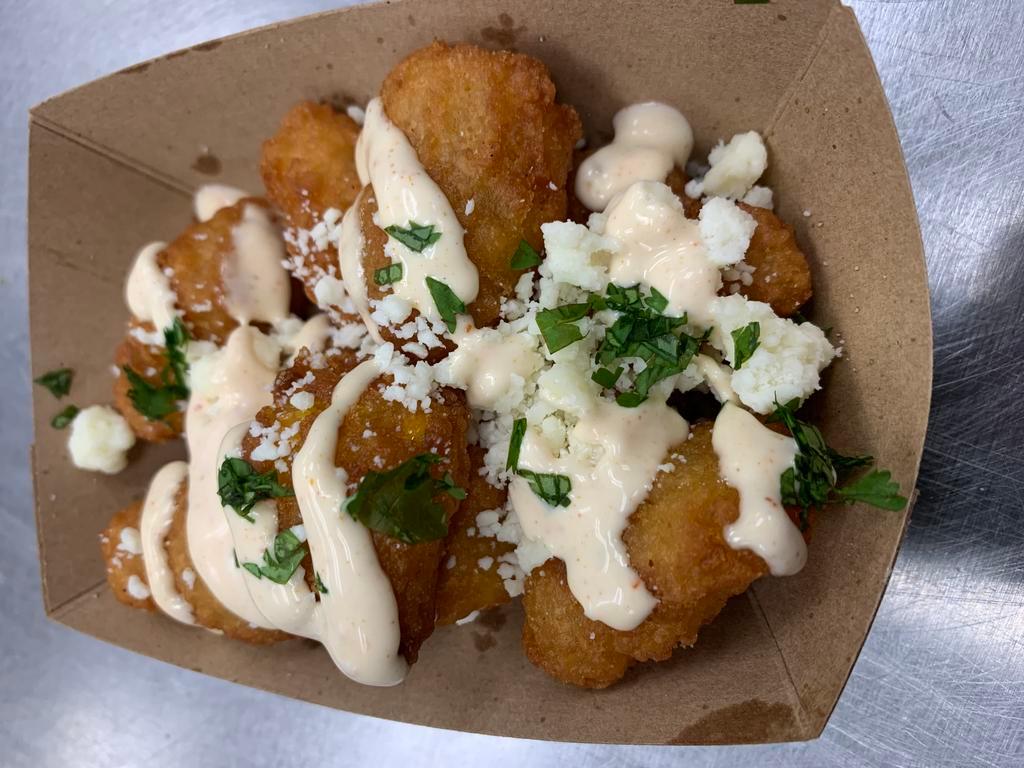 Street Corn Fritters · Fried corn fritters topped with cojita cheese & spicy mayo