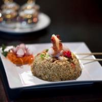 Tropical Fried Rice · Wok-fried jasmine rice with shrimp, chicken, pineapple, egg, onions and raisins, topped with...