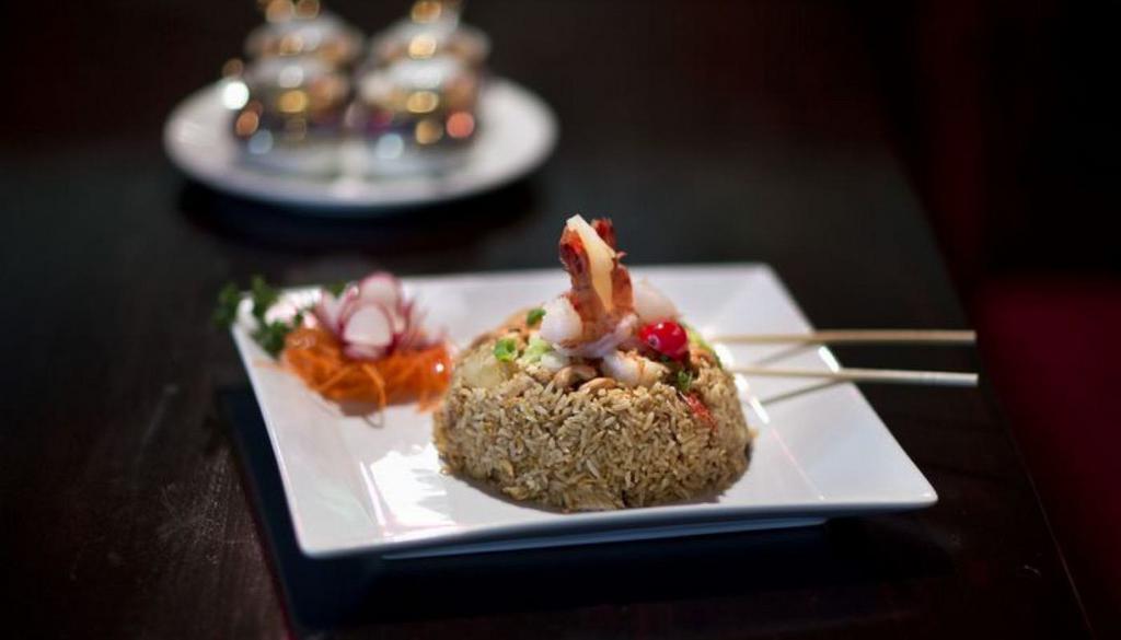 Tropical Fried Rice · Wok-fried jasmine rice with shrimp, chicken, pineapple, egg, onions and raisins, topped with cashew nut.