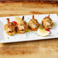 Stuffed Shrimp with Crab Meat  · Butterflied shrimp sauteed in garlic butter, stuffed with crab meat and served on top of a h...