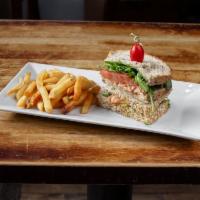 Grilled Salmon Sandwich · With arugula, tomato, and wasabi mayonnaise on thick-cut multi-grain toast. Served with one ...