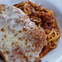 Chicken Parmigiana · Crispy chicken breast  served over home made linguine, with melted mozzarella cheese, Parmes...