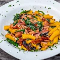 Penne Pasta with Salmon · Served with smoked salmon, mushrooms, sundried tomatoes, and spinach tossed in garlic infuse...