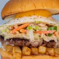 SLAW BURGER · impossible patty, white american cheese, fries, haus slaw, fried egg, and mayo