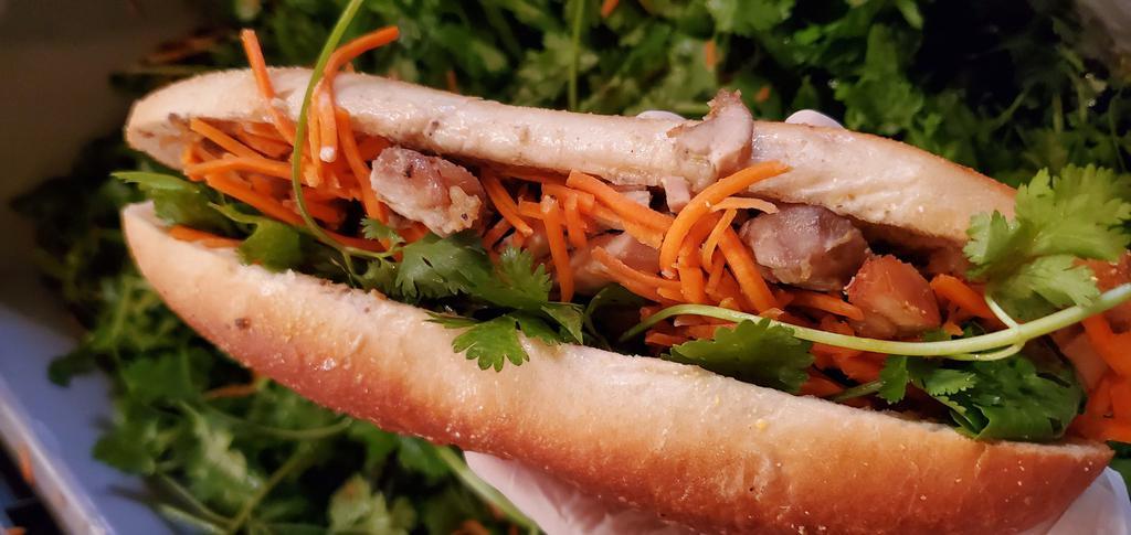 Pork Belly Banh Mi · All sandwiches come with pate, mayo, butter, cucumber, pickled carrots & daikon radish, and cilantro served on a toasted French baguette.
