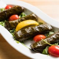 Stuffed Grape Leaves · 4 pieces. Hand-rolled grape leaves stuffed with currant, onion, dill, parsley, rice and herbs.