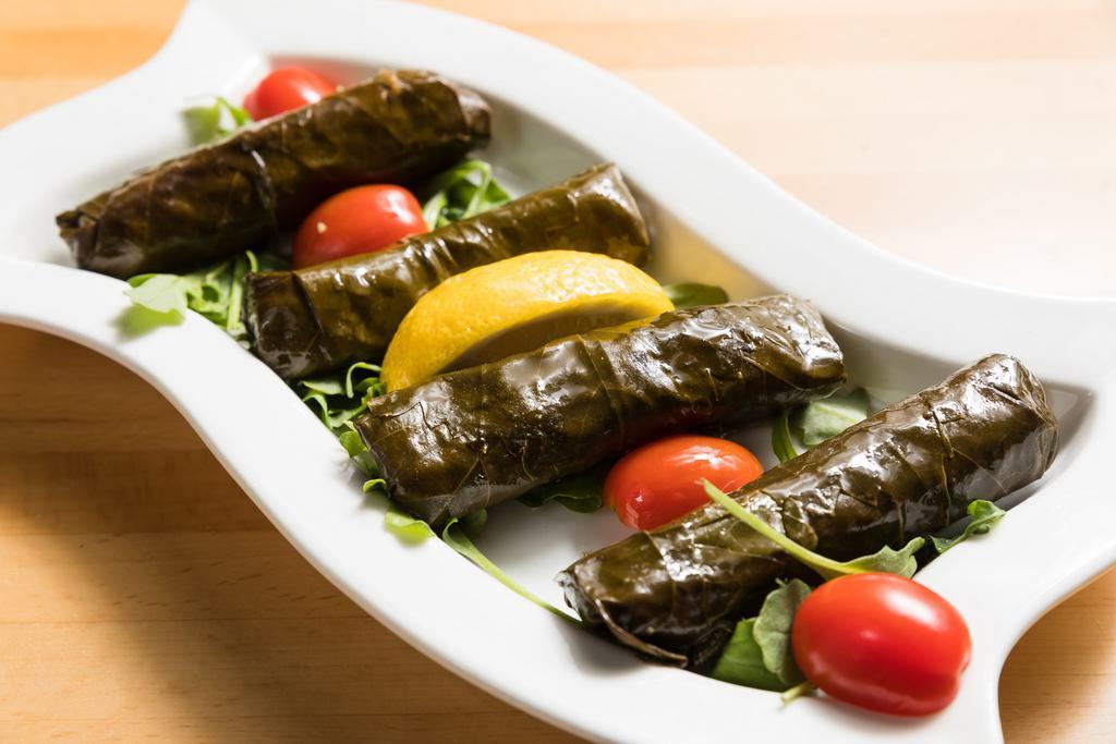 Stuffed Grape Leaves · 4 pieces. Hand-rolled grape leaves stuffed with currant, onion, dill, parsley, rice and herbs.
