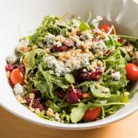 Arugula Salad · Fresh arugula, cranberry, walnut and blue cheese mixed in olive oil and balsamic vinegar.