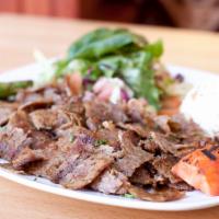 Lamb Gyro · Et doner. Layers of marinated lamb wrapped around the large vertical split and grilled in fr...