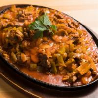 Lamb Saute · Tender pieces of lamb sauteed with onions, peppers, tomato and mushrooms. Served with rice.