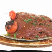 Iskender Kebab · Doner kebab served over homemade croutons topped with fresh tomato sauce and a healthy porti...