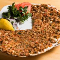 Lahmacun · A Turkish-style pizza. Flatbread dough topped with ground lamb and chopped tomato, peppers, ...