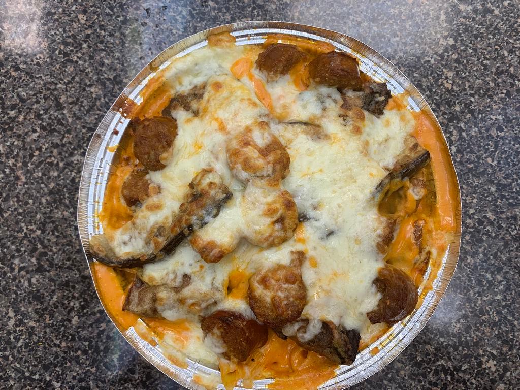 Baked Ziti Sicilian Dish · Served with eggplant and sausage.