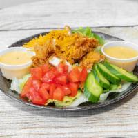 Crispy Chicken Salad · Crispy chicken, shredded cheese, cucumbers, tomatoes, carrots, lettuce & choice of dressing.