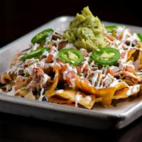 Cowboy Nachos · House Made Tortilla Chips, Pulled Chicken, Cheese Sauce, Black Beans, Pico de Gallo, Lime So...