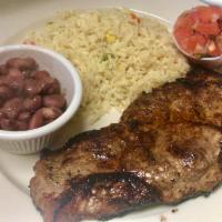 Bistec Corte Nueva York · NY Strip ( shell steak) with rice and beans