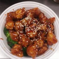 S4. Sesame Chicken芝麻鸡 · Chunks of chicken sauteed in a rich brown sauce, garnished with sesame seeds and flanked by ...