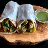 Chicken Curry Wrap · Boneless chicken marinated in yogurt and spices stewed in a spicy tomato sauce served with c...