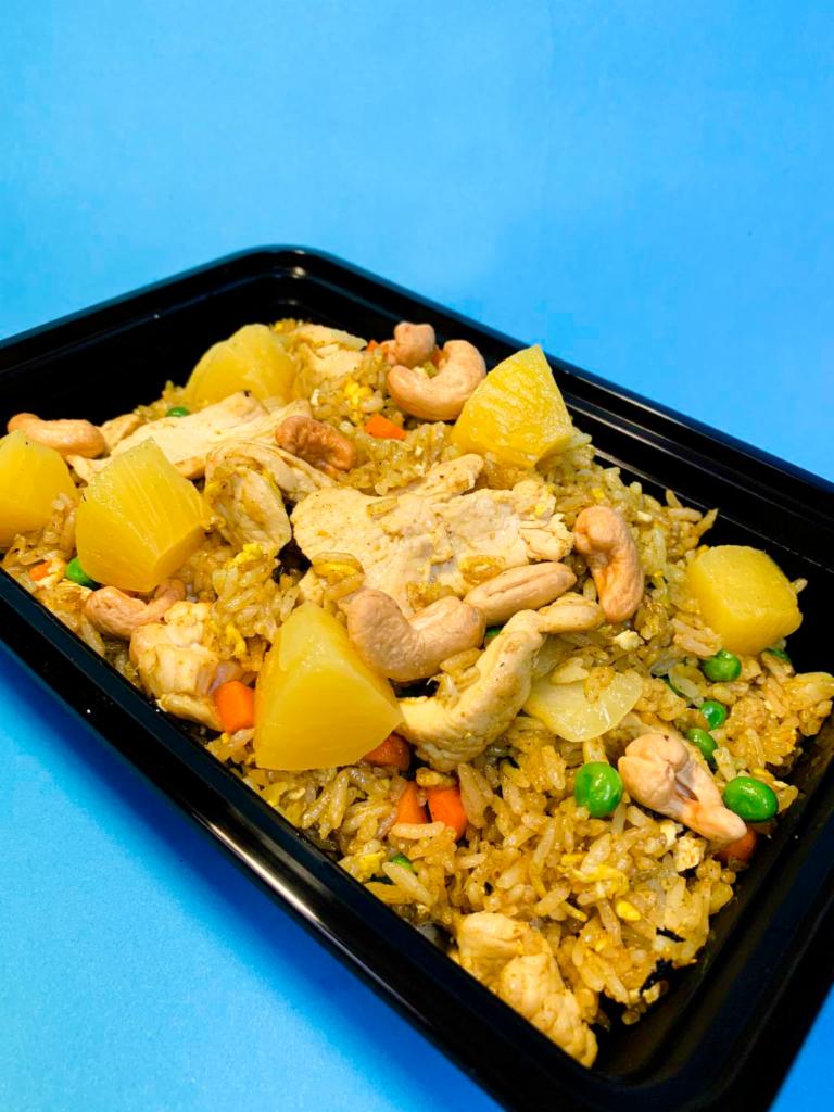31. Pineapple Fried Rice · Choice of protein, egg, onions, peas, carrots, pineapple, cashew nut, yellow curry powder.