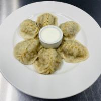 Lamb Manti Specialty · 6 pieces. Steamed dumpling filled with lamb, onions, and spices. Served with homemade yogurt.