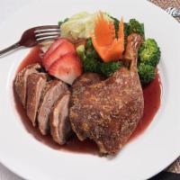 Crispy Duck · Half a duck, steamed broccoli, Napa, carrots and string beans. With your choice of sauce.