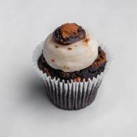 Peanut Butter Cupcake · Chocolate cake frosted with peanut butter cream cheese and topped with crushed Reese's peanu...