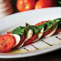 Insalata Caprese · Perfectly ripened Roma tomatoes, fresh mozzarella, and garden-fresh basil, drizzled with bal...