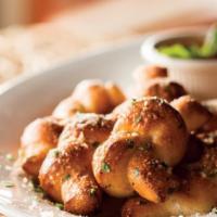 Truffle Garlic Knots · Hand-knotted pizza dough tossed with truffle olive oil, fresh garlic, and pecorino Romano ch...