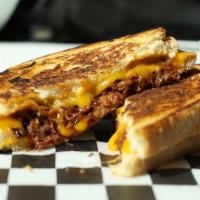 The Boss Sandwich · Slow-cooked BBQ brisket with melted sharp cheddar cheese grilled on sourdough bread.