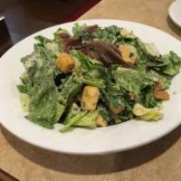 Classic Caesar Salad · Crisp romaine lettuce, seasoned croutons and fresh shaved Parmesan cheese tossed in creamy C...
