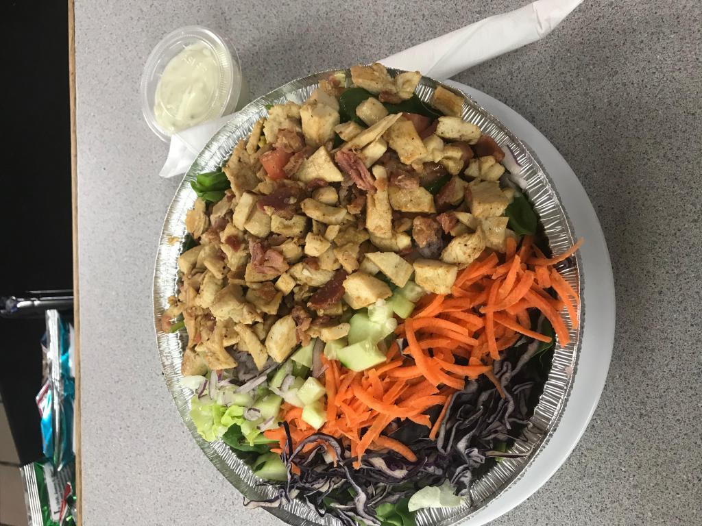 Cobb Salad · Spinach, tomato, cucumber, bacon, egg, onion, carrot, red cabbage and grilled chicken. Served with roll and butter.