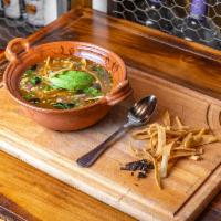 Tortilla soup · Traditional tortilla soup, onions, chihuahua cheese, avocado and pasilla Chile flakes. Add c...