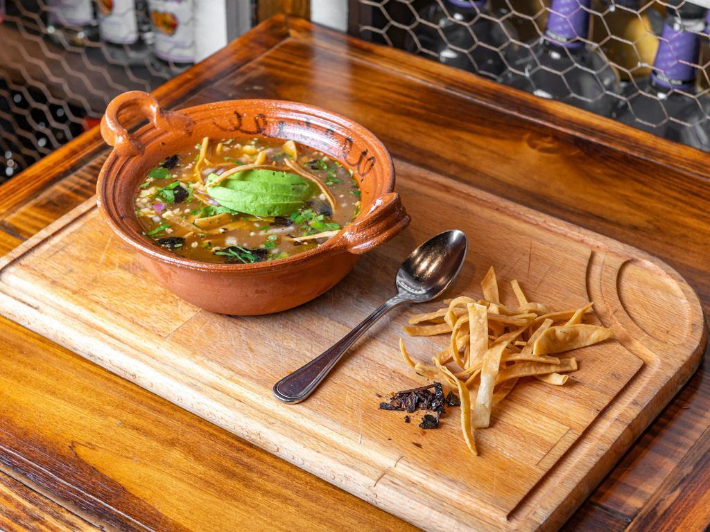 Tortilla soup · Traditional tortilla soup, onions, chihuahua cheese, avocado and pasilla Chile flakes. Add chicken for an additional charge.