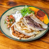 Carnitas Quesadilla · Flour tortilla with melted Jack cheese, pico de gallo, salsa and crema fresca on the side.