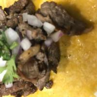 Carne Asada Taco · Grilled top sirloin steak taco with cilantro & onions on soft corn tortillas. Salsa will be ...