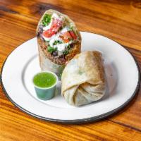 Pescado Baja Burrito · Pollock fish beer batter and rice bowls are served with black or pinto beans rice cabbage, p...